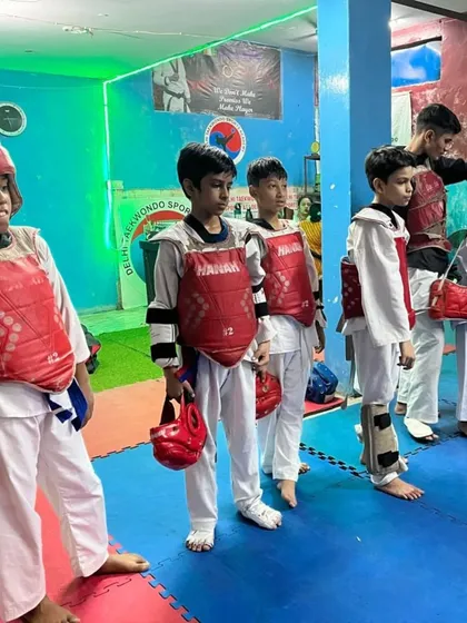 Preparation is key. My students are getting ready for sparring practice, fully equipped with protective gear. I make sure everyone, especially beginners, trains in a safe and structured environment.