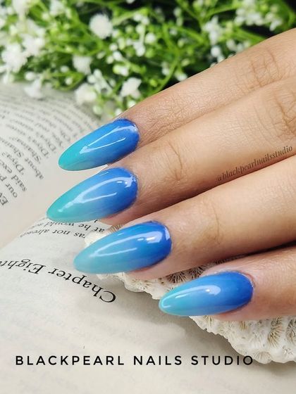 A beautiful example of a blue ombré, with shades that transition from a deep blue to a light seafoam green. This gradient effect is perfect for creating an ocean-inspired look.