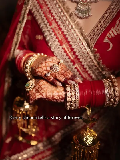 Your bridal story is incomplete without the perfect chooda and kaleere. This beautiful close-up captures the essence of tradition with intricate mehndi, classic red chooda, and golden kaleere, all available to purchase for your trousseau.