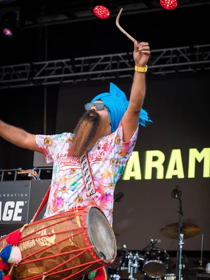 The dhol player for Param Singh's set, bringing incredible energy. The dhol is the heartbeat of Bhangra, and I always feature talented dholis in my event productions.