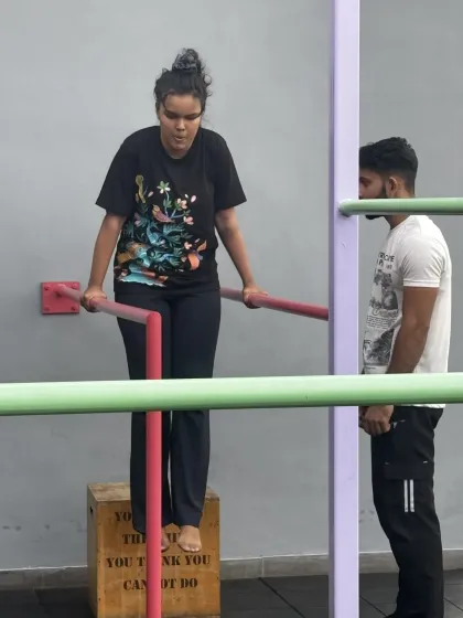 We ensure everyone, regardless of their starting point, feels confident and capable. Here, a member works on her dip progression with a coach right by her side, offering encouragement and ensuring her technique is safe.