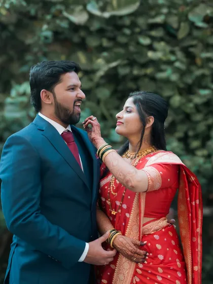 A playful moment where the bride touches the groom's beard.