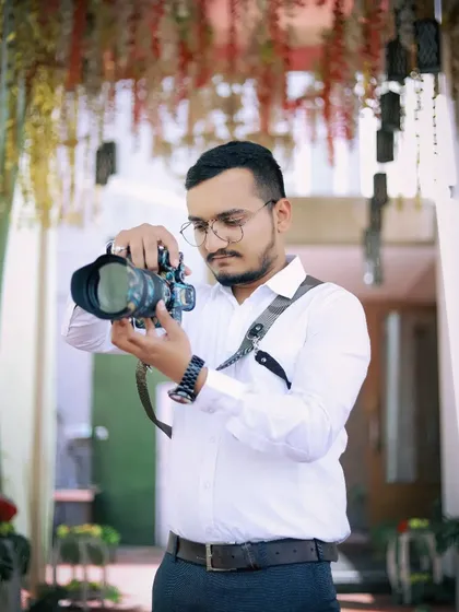 Here I am in my element, making fine adjustments to my camera during a wedding shoot. Capturing the perfect shot is all about focus and attention to detail.