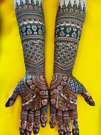 A gorgeous full-coverage design with a dark, rich stain. The pattern uses geometric and floral motifs to create a dense and captivating look.