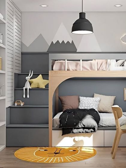 A cozy and adventurous kid's room with a mountain-themed mural. The bunk bed features a staircase with built-in storage and a desk, creating a perfect nook for study and sleep.