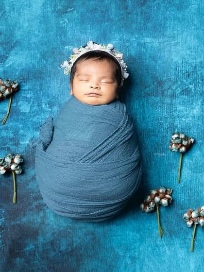 When you photograph newborns, you want to create something beautiful every single time. This shot, with its blue tones and delicate flowers, is a perfect example.