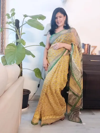 I love the breezy feel of a Kota Doriya saree, especially in the summer. I styled this yellow one with a contrast black blouse and simple silver earrings for an easy, elegant look.