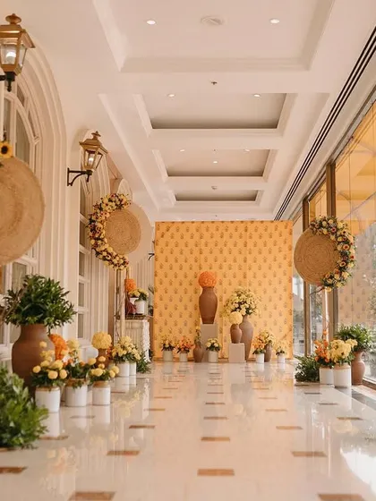 The entrance corridor lined with traditional terracotta vases, pickle jars, and an abundance of yellow and orange marigolds.