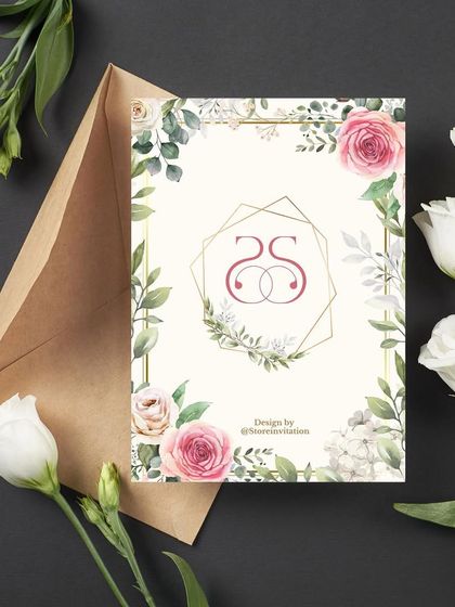 The monogram reveal for Sahith and Srivani's engagement. Their intertwined "SS" logo is set within a geometric gold frame, surrounded by the same beautiful floral and greenery theme.