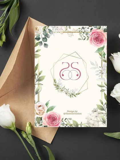The monogram reveal for Sahith and Srivani's engagement. Their intertwined "SS" logo is set within a geometric gold frame, surrounded by the same beautiful floral and greenery theme.