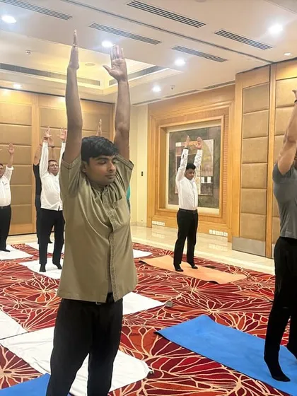 We guide employees at the Radisson Hotel through a standing asana. Our corporate yoga programs are designed to be practical and can be done in office wear, focusing on improving posture and energy levels during the workday.