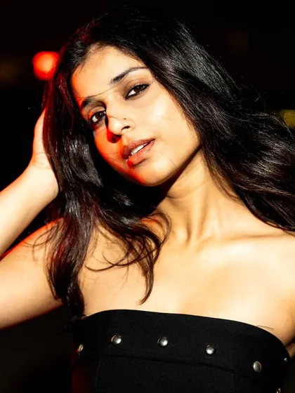 Using a touch of red light from the side to add a pop of color and a bit of mystery to this nighttime portrait.
