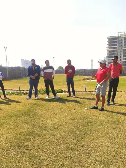 A group of golfers, including juniors, gathers to learn from pro golfer Simi Mehra during an exclusive masterclass on our practice green.
