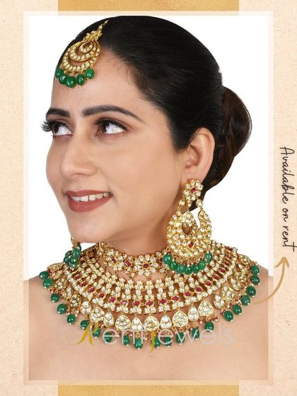 This model showcases a classic Kundan choker with green and ruby accents. It's a versatile piece that pairs beautifully with many traditional bridal colors.