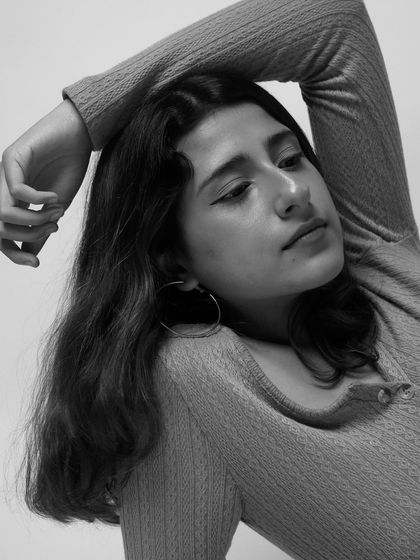 "Tell me stories in the shades of grey." A black and white portrait.