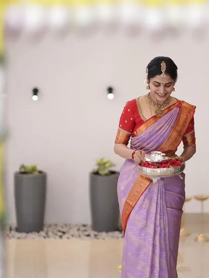 Another shot of the bride during her housewarming ceremony, her smile as bright as her outfit.
