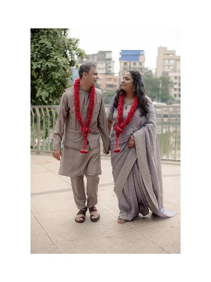 Susheta and Abhishek walking hand-in-hand after their ceremony. The simple act of walking together, sharing a look, often creates the most beautiful and honest portraits.