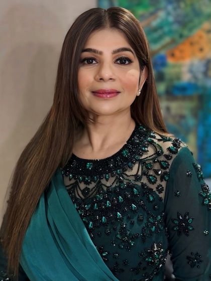 This full-face portrait shows the complete harmony between the hair, makeup, and the client's elegant attire, creating a polished and put-together appearance.