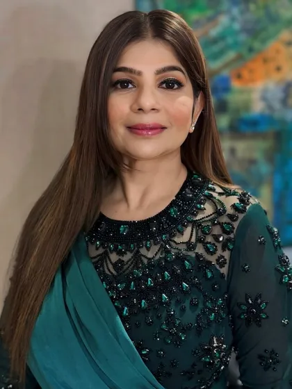 This full-face portrait shows the complete harmony between the hair, makeup, and the client's elegant attire, creating a polished and put-together appearance.