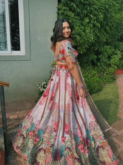 A full-length shot of this stunning floral lehenga. The soft, natural makeup allows the intricate details of the outfit to shine.