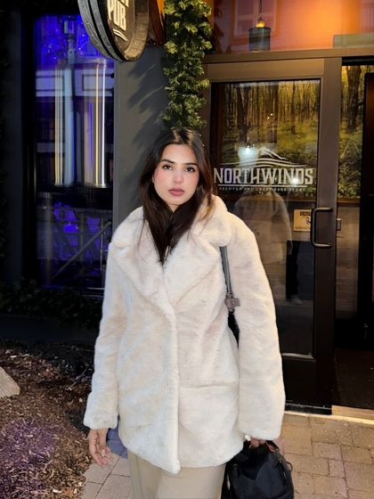 A direct-to-camera portrait at night in Blue Mountain, showing the full winter outfit.