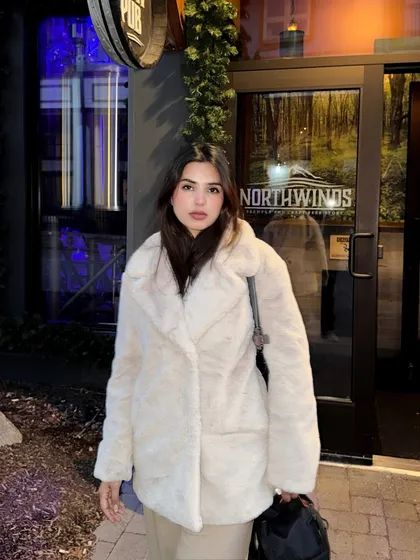 A direct-to-camera portrait at night in Blue Mountain, showing the full winter outfit.