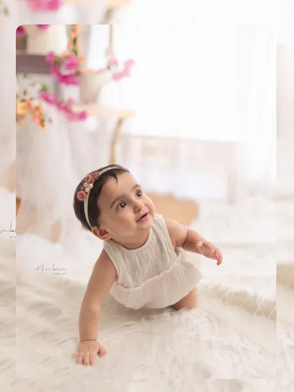 Capturing the crawling milestone. This baby looks up with a curious and sweet expression, perfectly showcasing this active and adorable stage.
