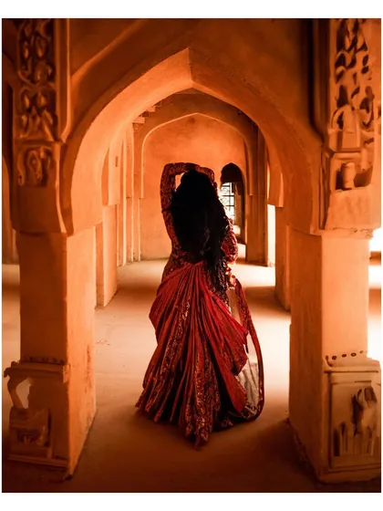 The 'after' shot. Using Adobe Firefly's AI tools, I transformed the original image into an artistic masterpiece. The AI generated a stunning red bridal lehenga and enhanced the environment, showing how I integrate technology to bring a creative vision to life.