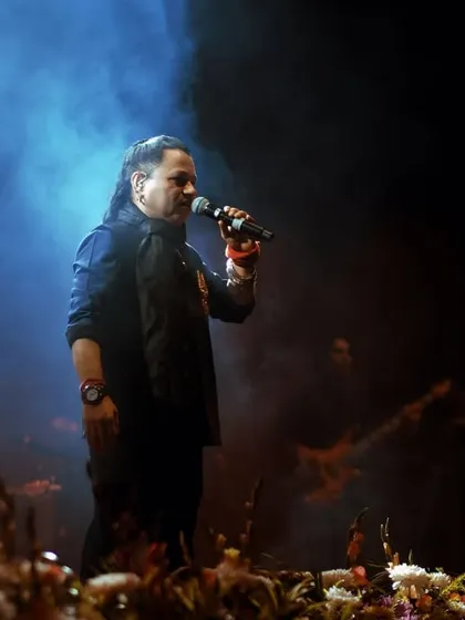 A moody, atmospheric shot of Kailash Kher on stage, surrounded by smoke. This frame captures the soulful and introspective side of his musical performance.