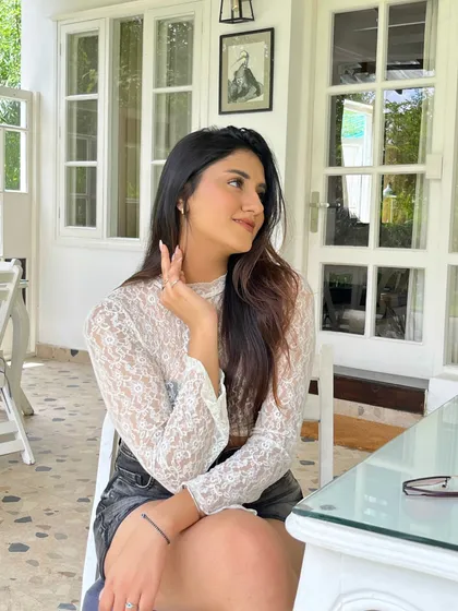 A brunch look in Kasauli. A delicate white lace top paired with a black denim skirt.