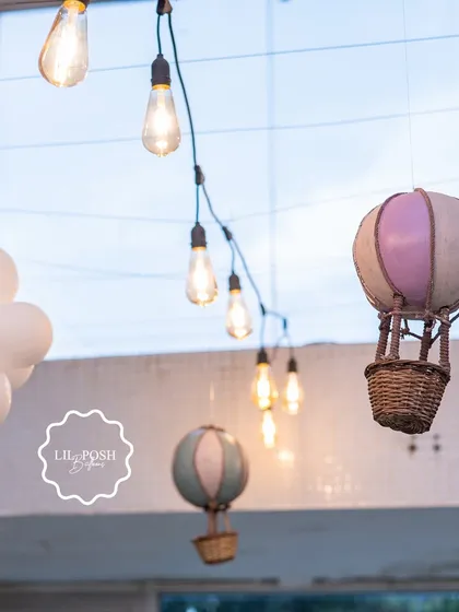 Miniature hot air balloons and soft string lights created a magical canopy over the guests at this dreamy baby shower.