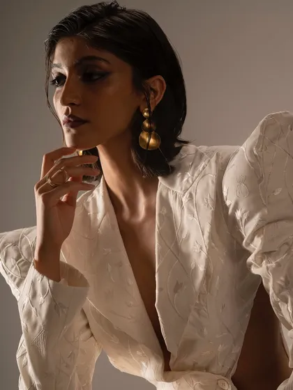 A sharp, high-fashion look for the Kachiwala brand shoot. The focus is on a bold, winged eyeliner and a deep, vampy lip.