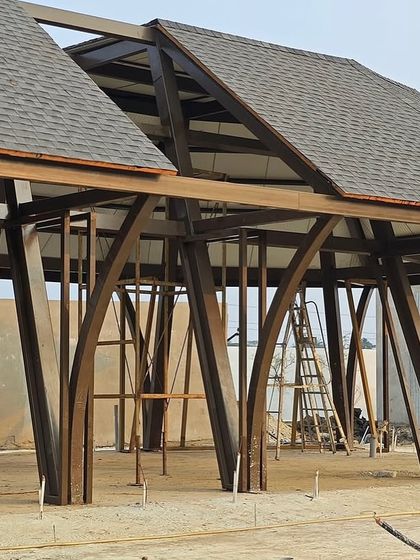 A detail shot of the structural work for a luxury villa in Bhubaneswar. The arched steel framework highlights the unique architectural elements and the precision involved in constructing a design that is both extravagant and structurally sound.