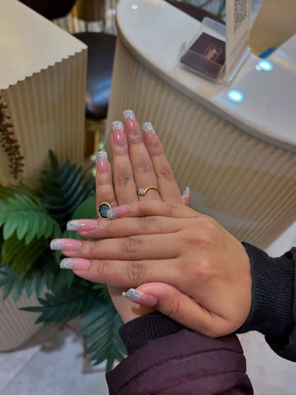 Another view of our beautiful coffin-shaped extensions with silver glitter French tips. A popular choice for clients who love a bit of sparkle.