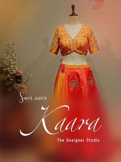 A complete look at our orange and red lotus-motif lehenga on a mannequin. This view highlights the contrast between the embroidered blouse and the flowing, dual-toned skirt, showcasing a perfect blend of color and craft.