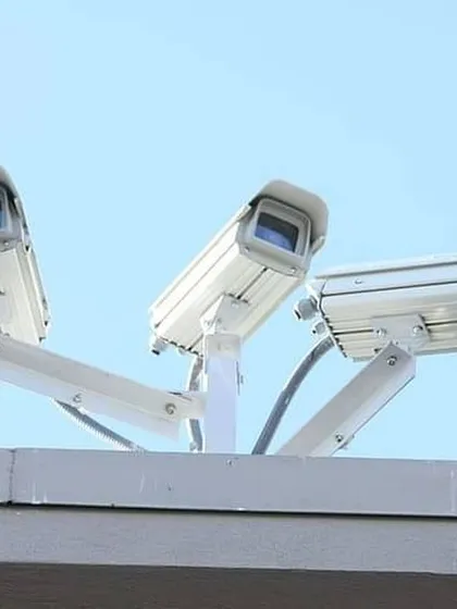 This trio of security cameras mounted on a rooftop demonstrates how we can create a comprehensive surveillance perimeter for any commercial building.
