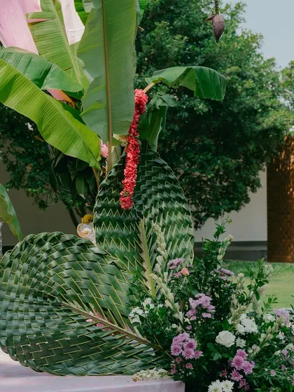 A detail of the eco-friendly decor, using intricately woven coconut palm leaves, a sustainable and traditional South Indian element.