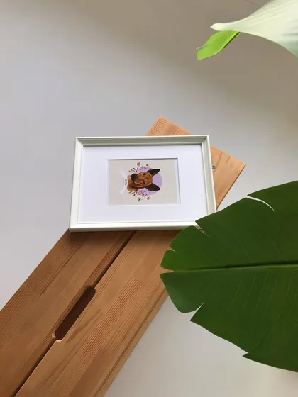 This framed portrait of Chiku is displayed in my studio. The simple white frame is versatile and fits well with the minimal, nature-inspired decor.