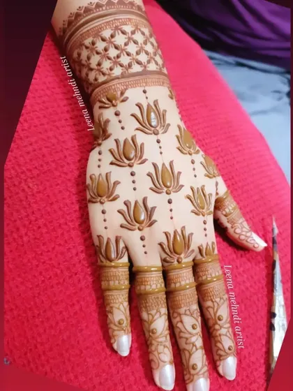 The finished single hand with the repeating lotus pattern. This is a great choice for someone who wants a modern and elegant design.