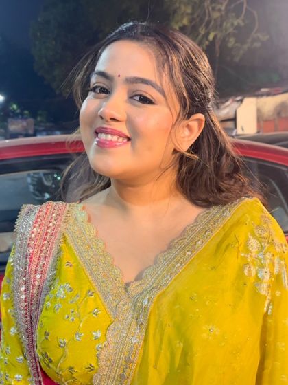 A happy smile and beautiful hair. This simple half-up style is elevated with a traditional hair accessory.