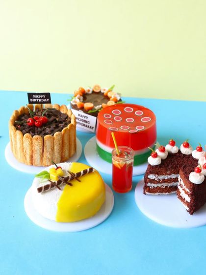 A collection of my miniature cakes, including a slice of black forest cake and a mango cake.