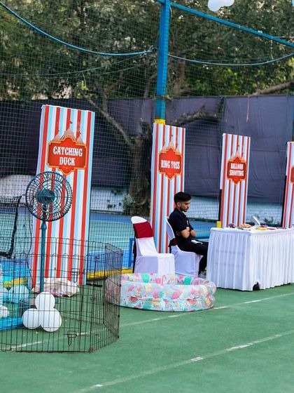 A row of classic carnival game booths, including rabbit feeding, catching ducks, and ring toss, providing endless entertainment for the kids.