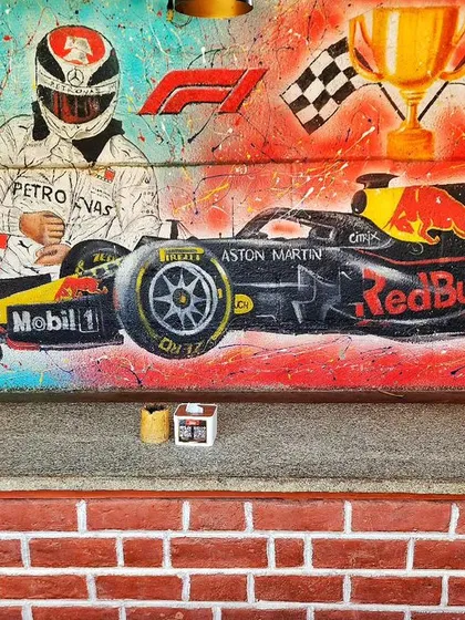 We brought the high-octane energy of Formula 1 to the walls of Burnout Café. This detailed street art piece features racing legends and a Red Bull F1 car, creating a perfect backdrop for a motorsports-themed space.