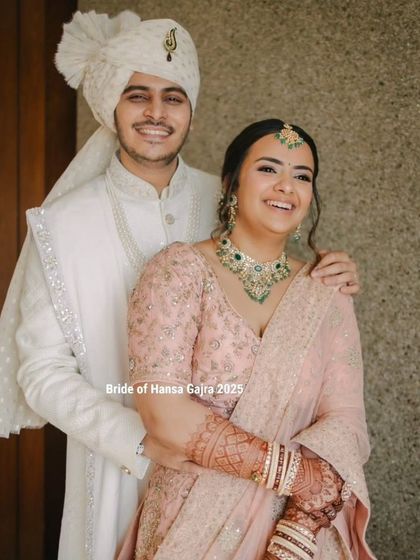 A happy couple radiating timeless elegance. The bride's blush-toned lehenga and her beautifully stained mehendi create a soft and romantic bridal look.