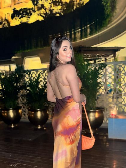 A confident pose in a multi-colored backless dress. This shows how I can model and style for different body types and aesthetics.