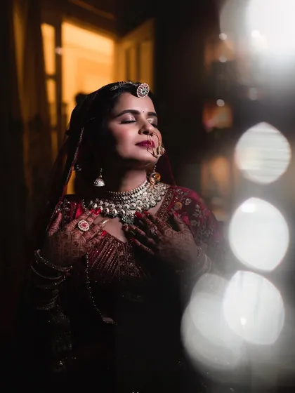 An artistic bridal portrait capturing a moment of serene beauty. I used soft lighting and a shallow depth of field to create a dreamy, ethereal feel, highlighting the bride's intricate jewelry and peaceful expression.