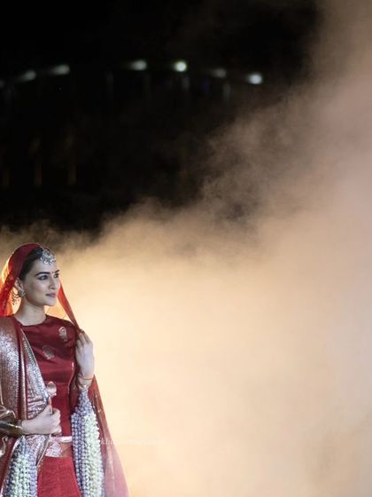 A wide shot of Kriti Sanon enveloped in atmospheric smoke on the runway, creating a dramatic and unforgettable fashion moment.