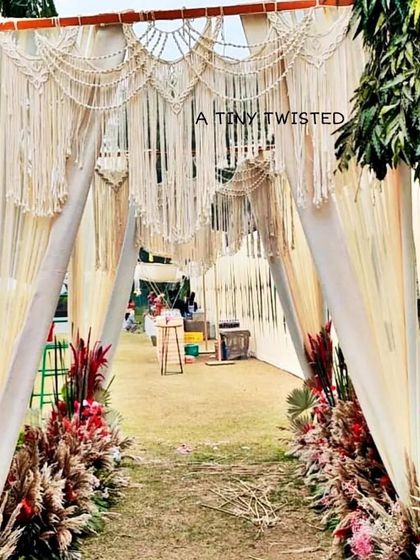 Another view of the magnificent macramé wedding gate. The way it frames the entrance and welcomes guests is just so dreamy. We can customize these arches for any event, in any size or color.