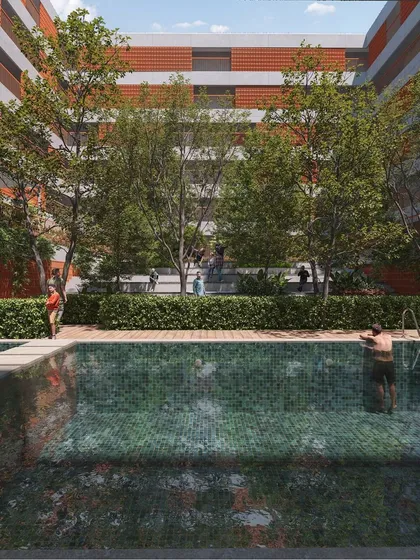This view showcases the relationship between the architecture and the landscape. The swimming pool is surrounded by dense greenery and seating areas, creating a resort-like feel within the residential community.