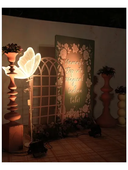 "Namaste, Step into a Magical Indian Tale!" This custom sign, lit by a butterfly lamp, welcomed guests and set the stage for the enchanting experience to follow.